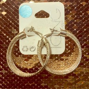 NWT Silver tone twist braid hoop earrings.